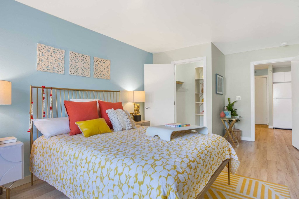 a bedroom with a bed and a door to a bathroom