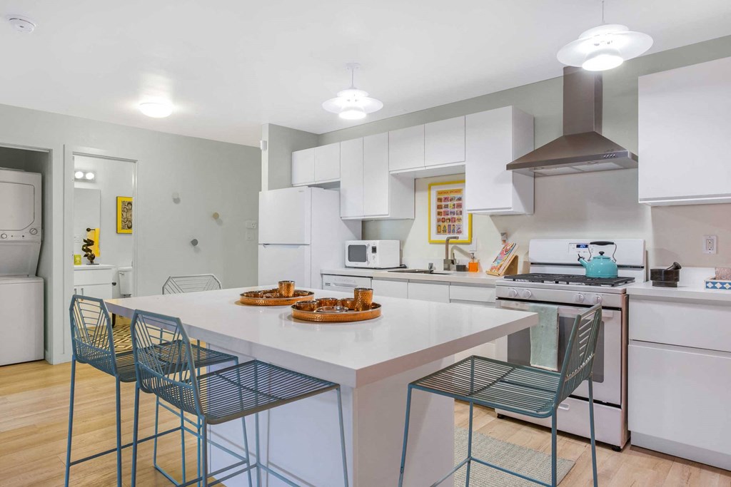 a kitchen with an island and a table with chairs
