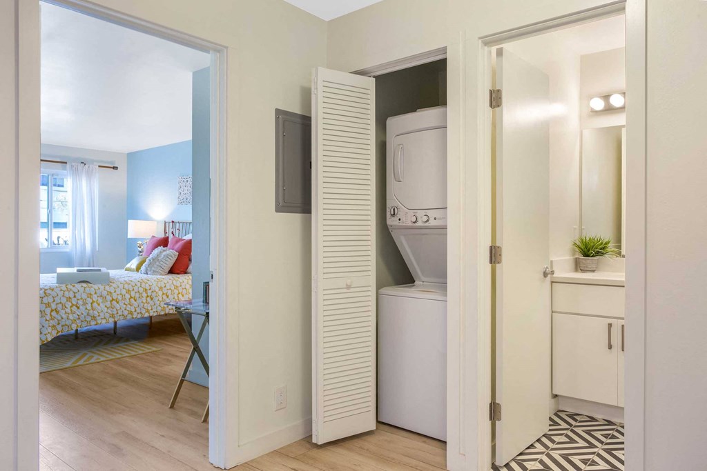 a bathroom with a washer and dryer in a room
