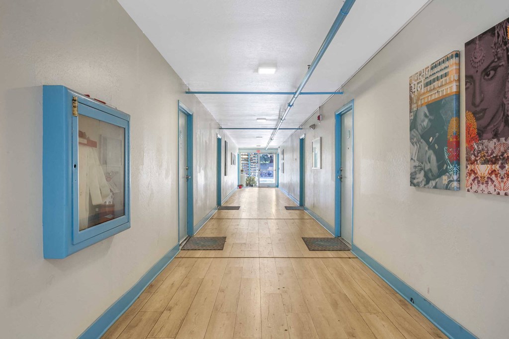 a room with many different paintings and wood floors