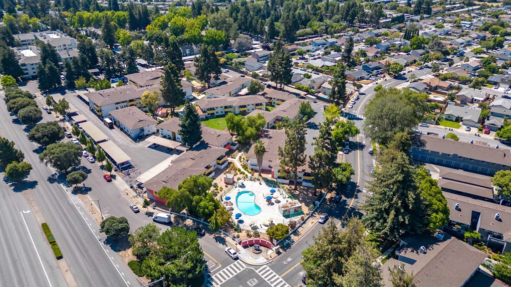an aerial view of a swimming pool in the middle of a city