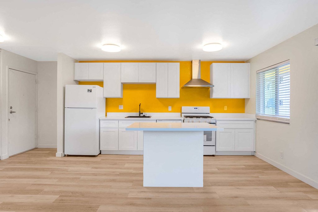 a kitchen with white cabinets and a counter top