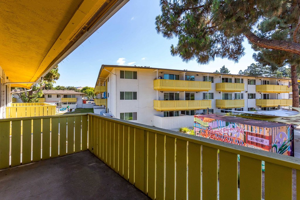 a balcony or terrace with a yellow fence