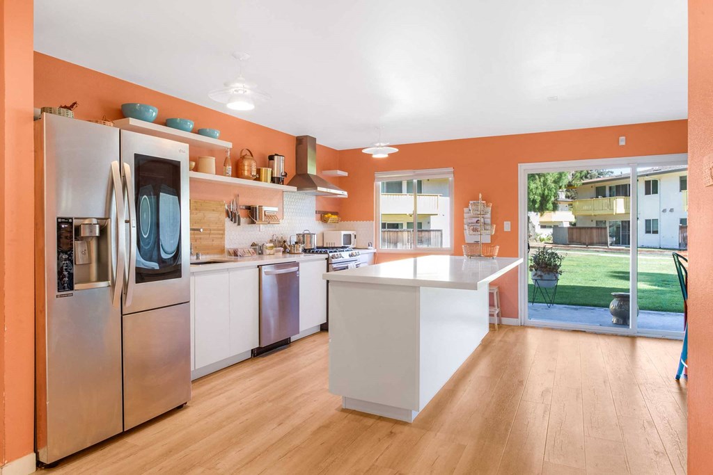 a kitchen with an island and stainless steel appliances
