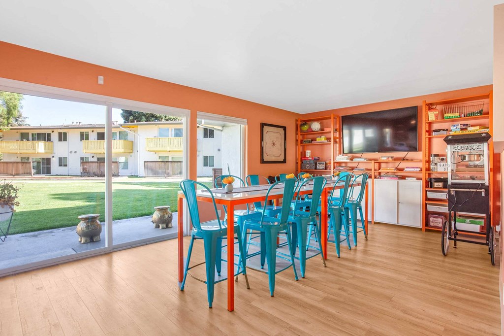 a dining room with a table and chairs and a television