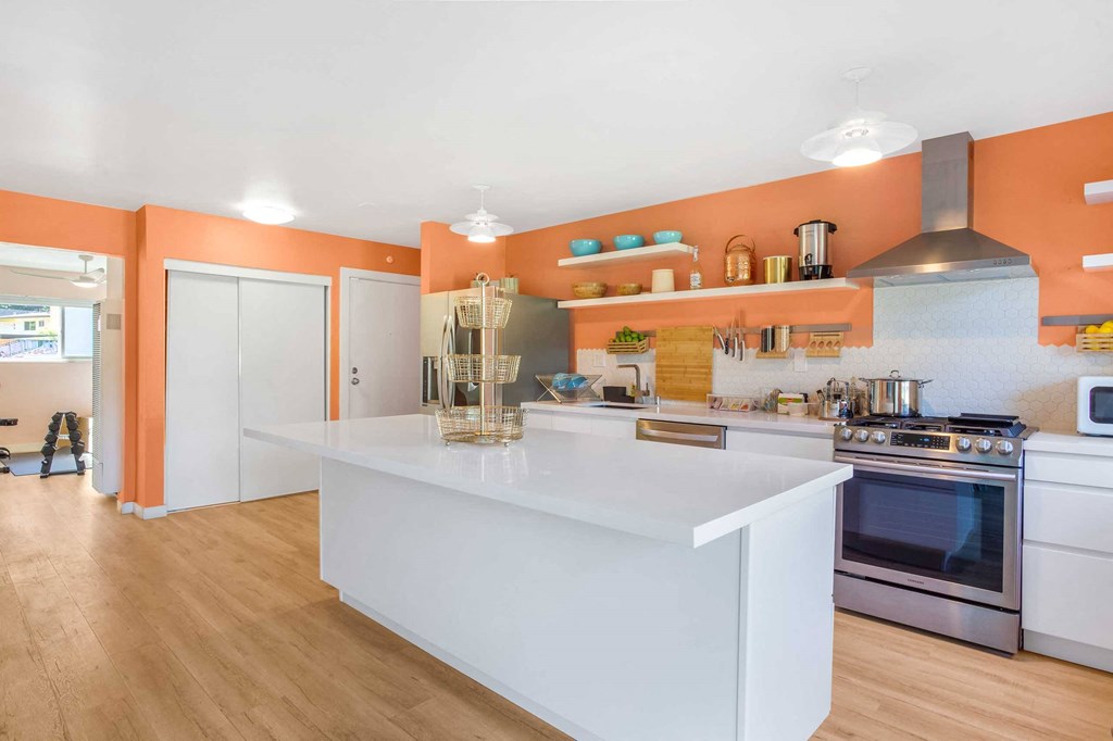 a spiraled room with white tables and orange walls