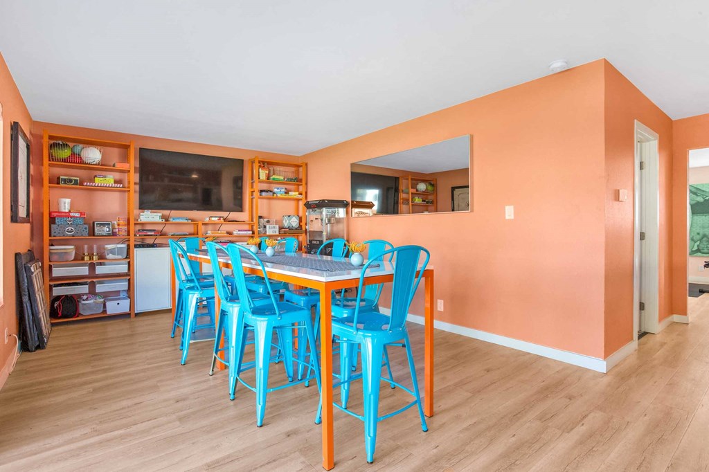 a dining room with blue chairs and a table