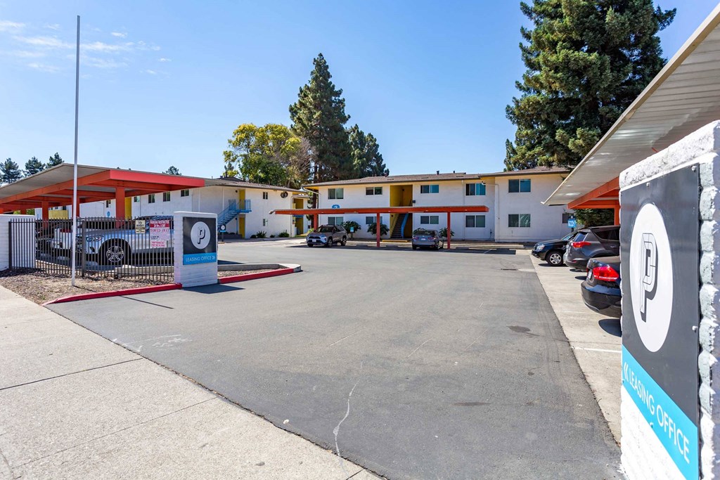 an empty parking lot in front of a motel