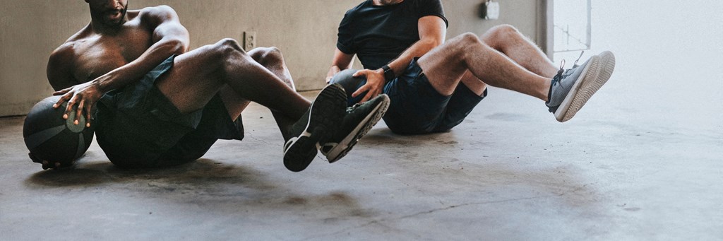 two men sitting on the floor with their shoes off