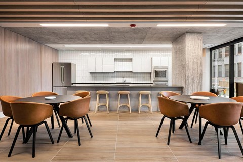 A modern kitchen with a dining table and chairs.