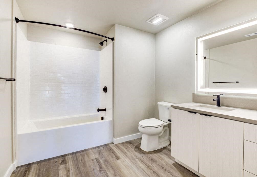 a bathroom with a toilet and a shower and a sink