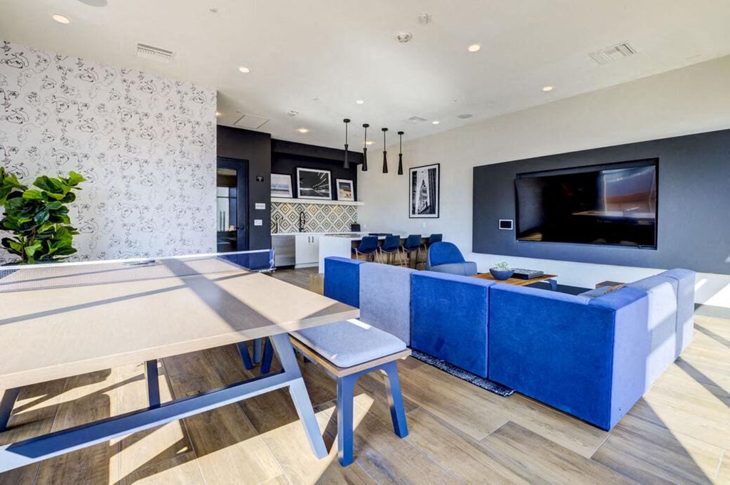 a living room and dining room with a table and a television