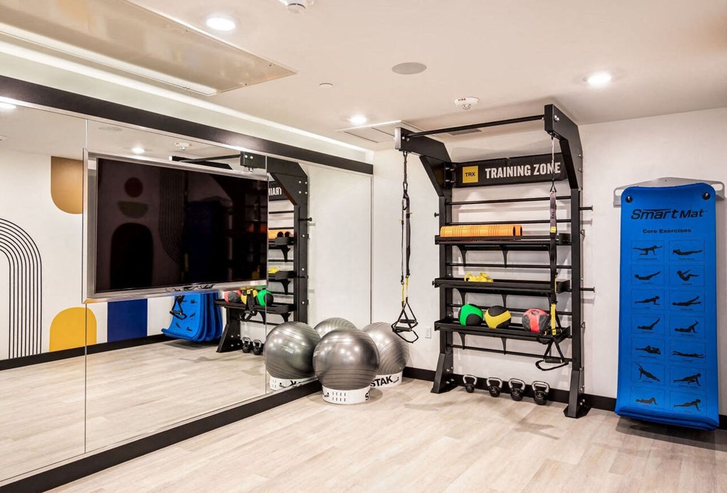a home gym with weights and a television
