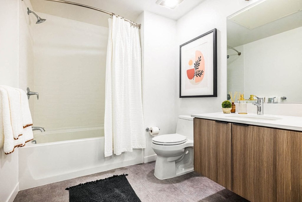 a bathroom with a toilet and a shower and a sink