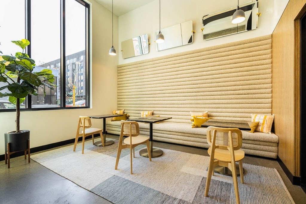 a restaurant with tables and chairs and a large window