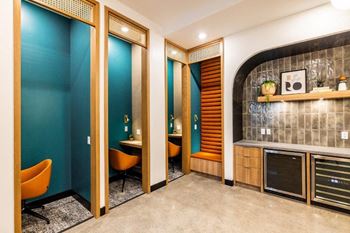 a public restroom with blue walls and orange chairs