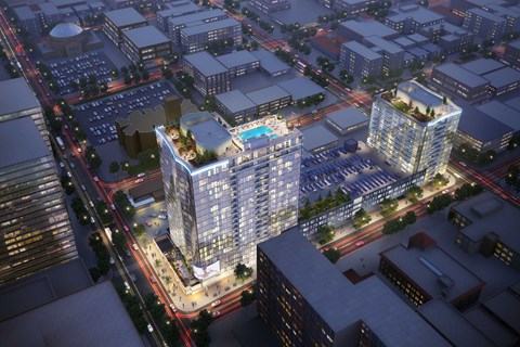 an aerial view of a city at night with tall buildings