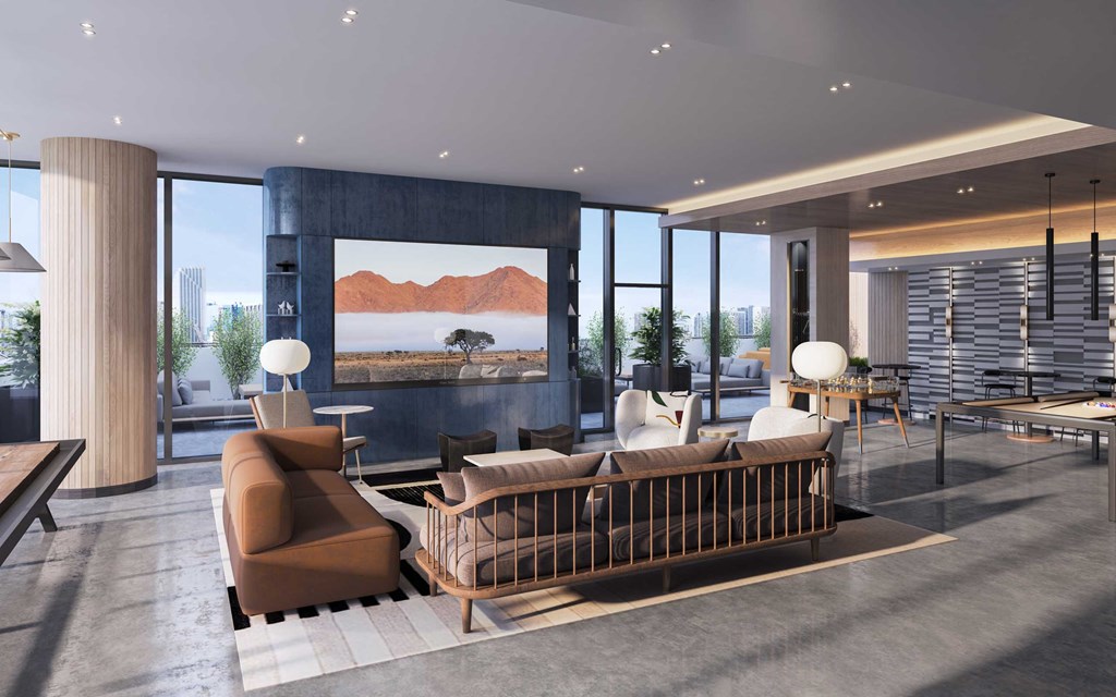 a living room with a couch and chairs and a television