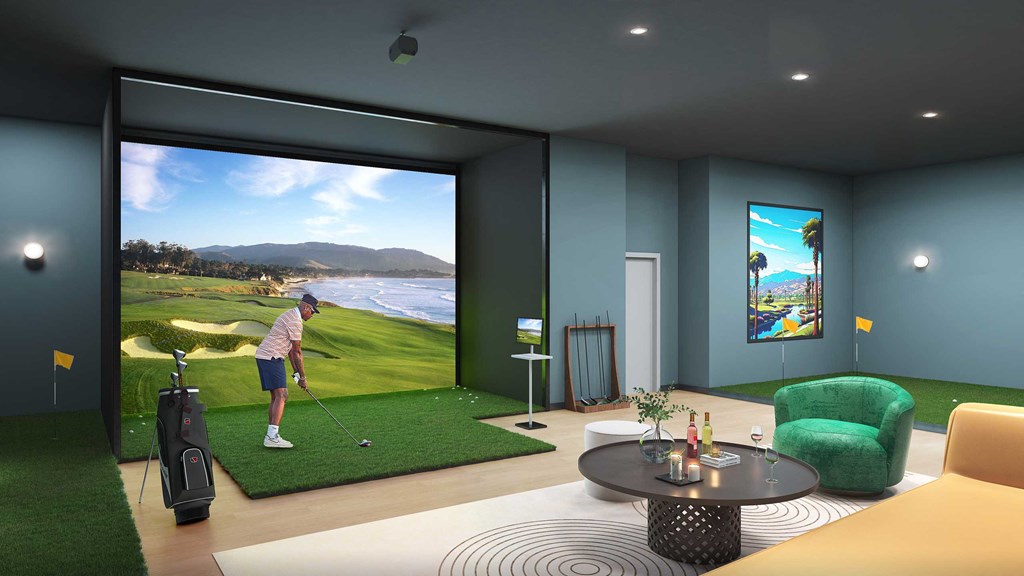 a man playing golf in a living room with a golf simulator