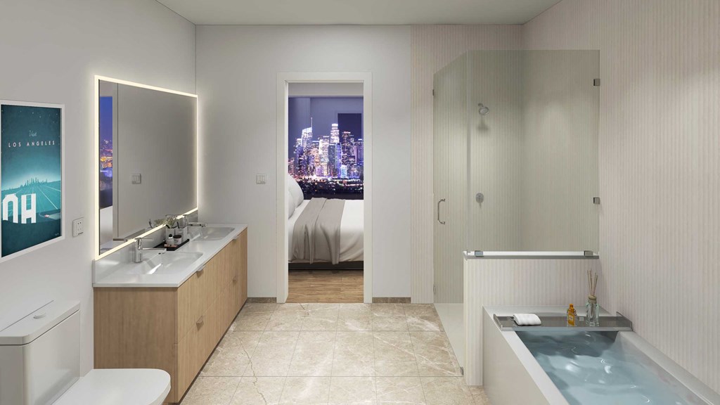 a bathroom with a tub and a sink and a door to a bedroom