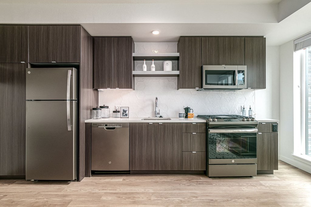 a kitchen with stainless steel appliances and wooden cabinets
