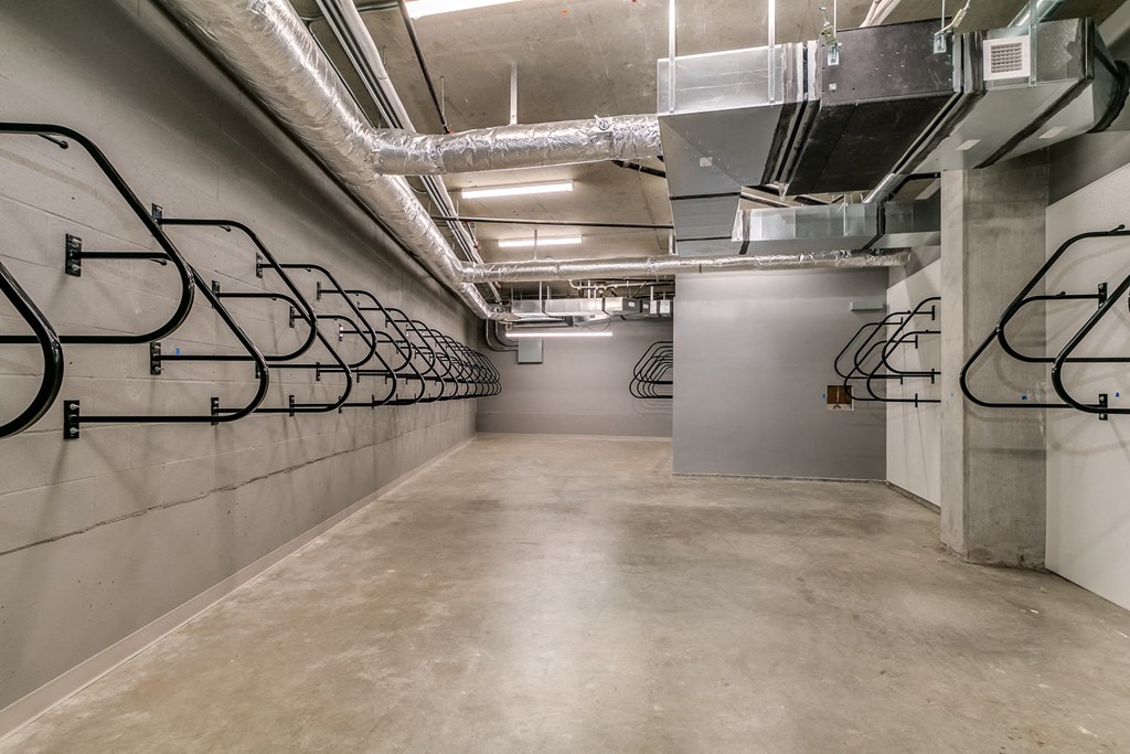 the lobby of the building has a wall of bike racks