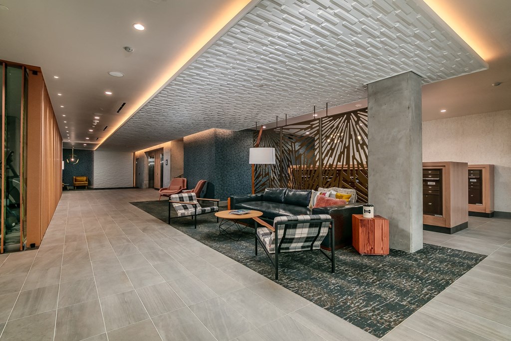 the lobby of a hotel with couches and chairs