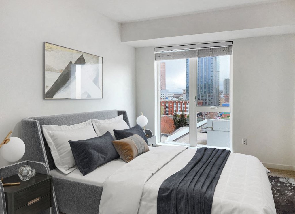 a bedroom with a bed and a large window