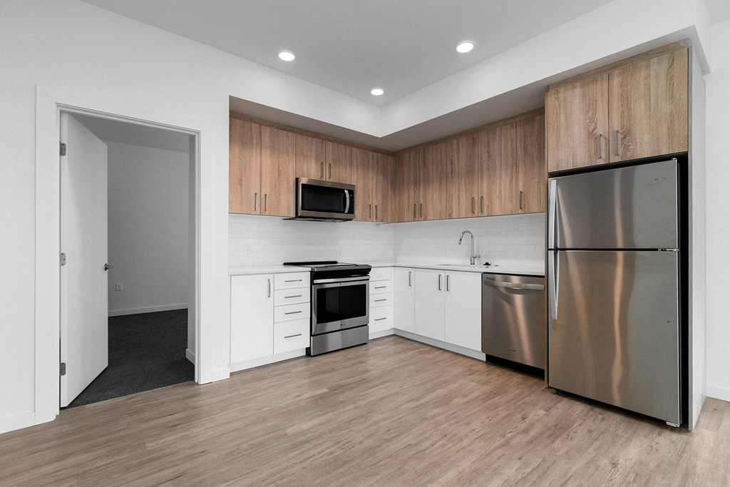 a kitchen with white cabinets and stainless steel appliances