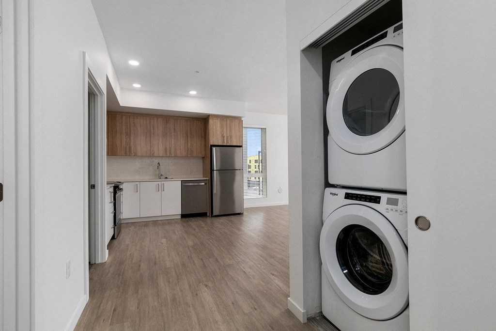 a washer and dryer in a living room with a kitchen