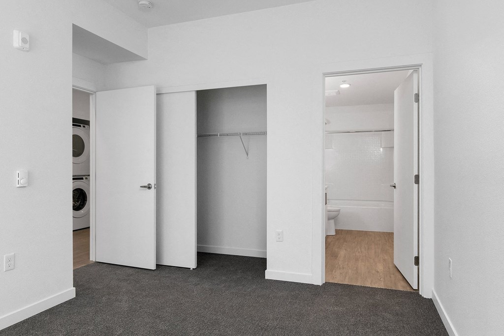 an empty room with a laundry room and a washer and dryer