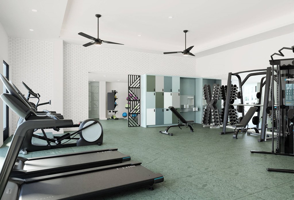 a gym with treadmills and other exercise equipment in a room with white walls