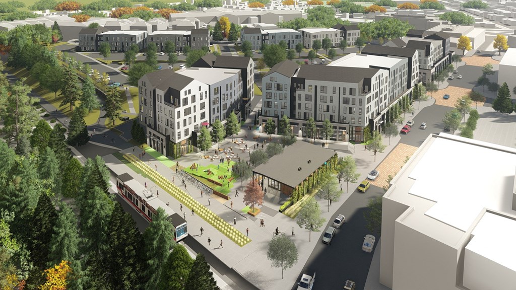 an aerial view of a city street with buildings and trees
