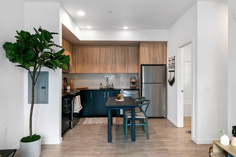 a kitchen and dining room with a table and chairs