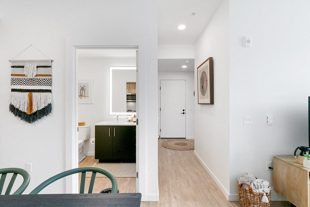 the view from the dining room into the kitchen and the living room of a home