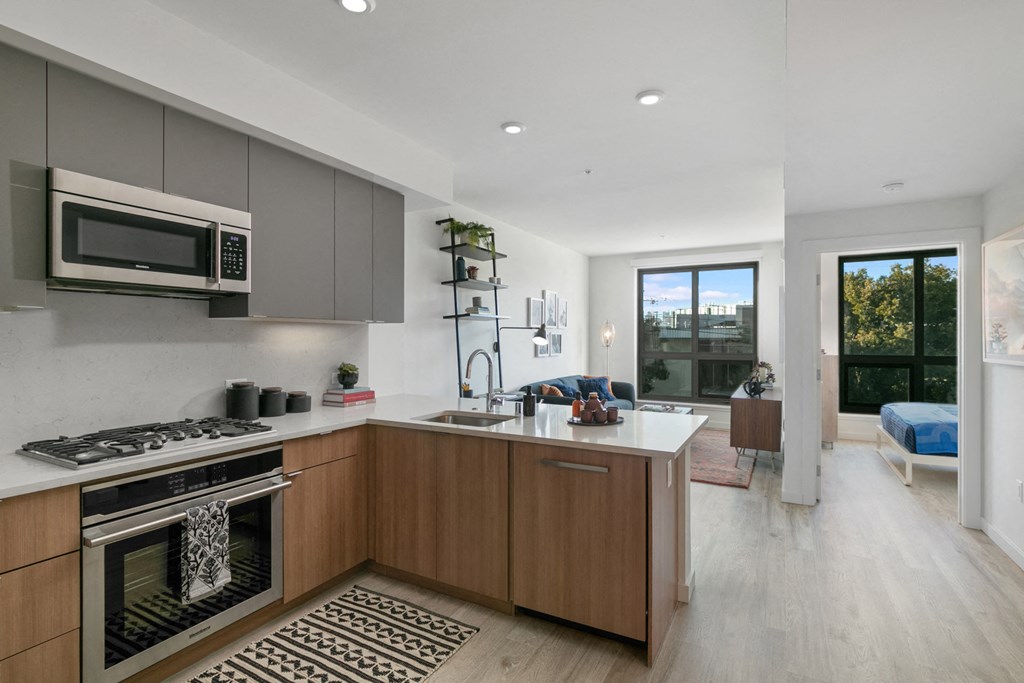 a kitchen with a sink and a stove and a microwave