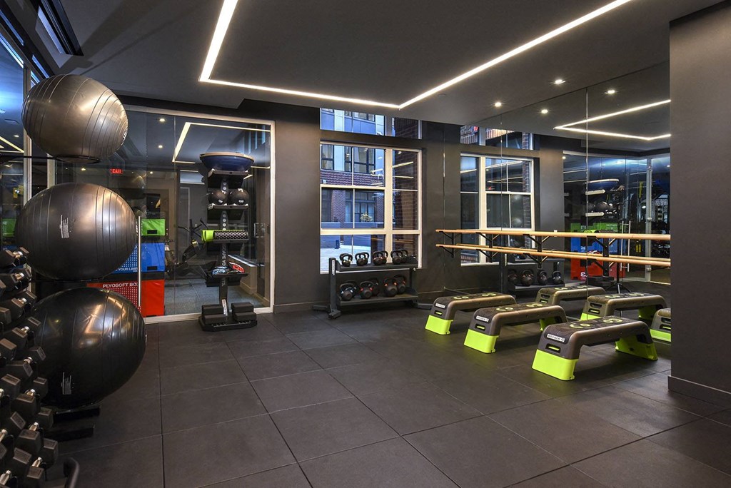 a workout room with weights and exercise equipment in a gym