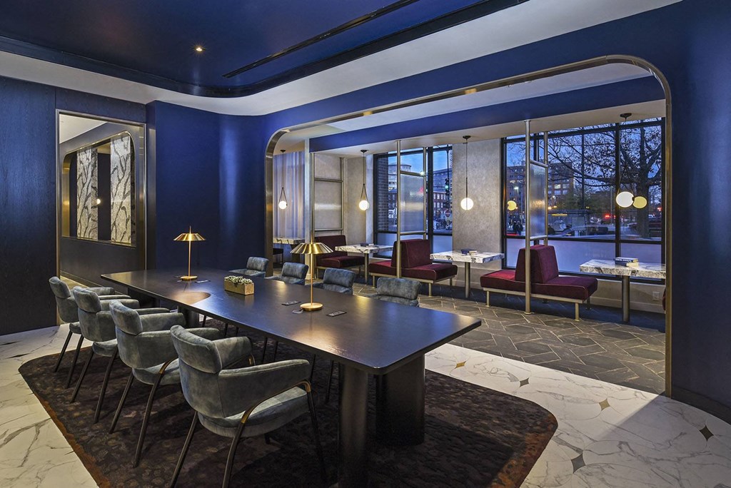 a conference room with a long table and chairs and a large window