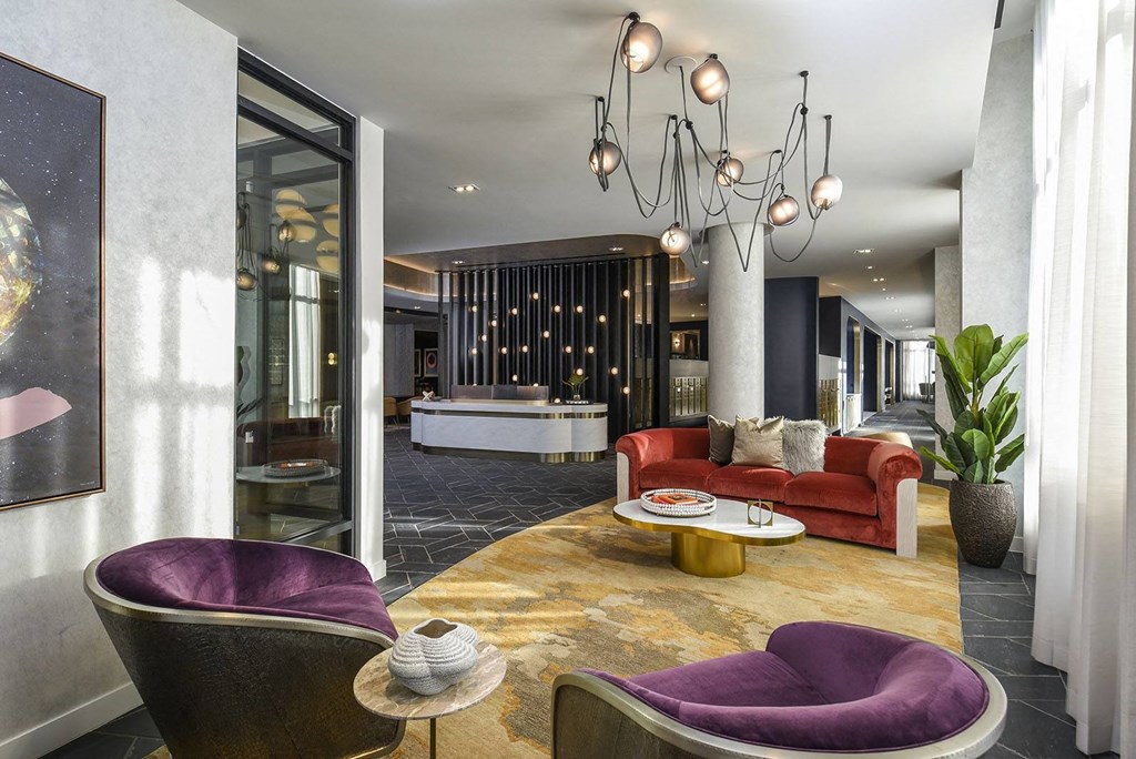 a lobby with couches and chairs and a table