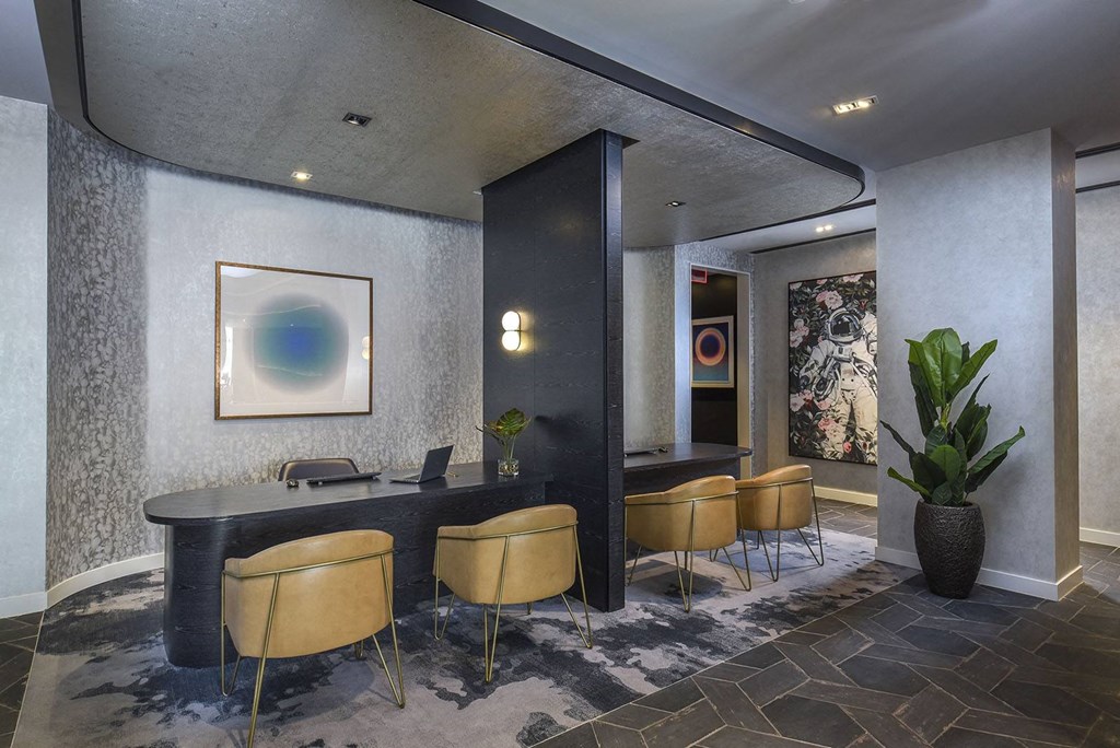 a room with a table and chairs and a painting on the wall