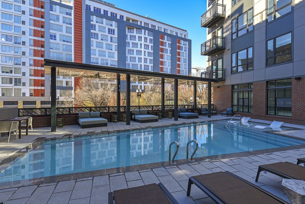 a swimming pool with a building in the background