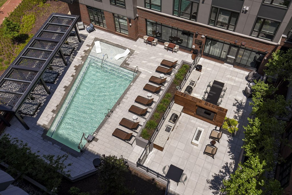 an aerial view of a pool in the middle of a building