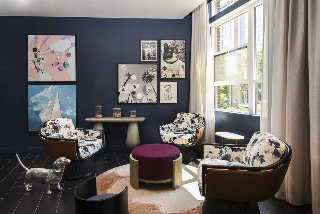 a living room with blue and white furniture and a large window