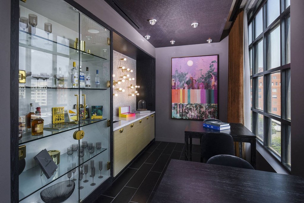 a tasting room with glass shelves and a table and chairs
