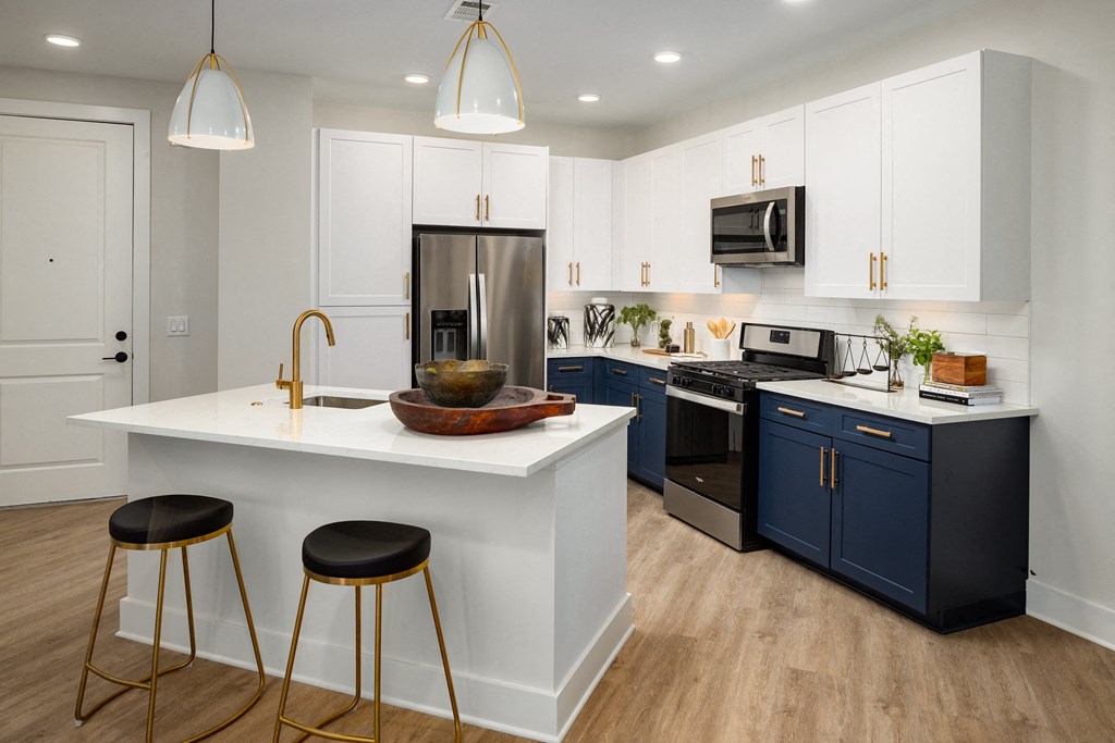 a kitchen with blue and white cabinets and a white counter top