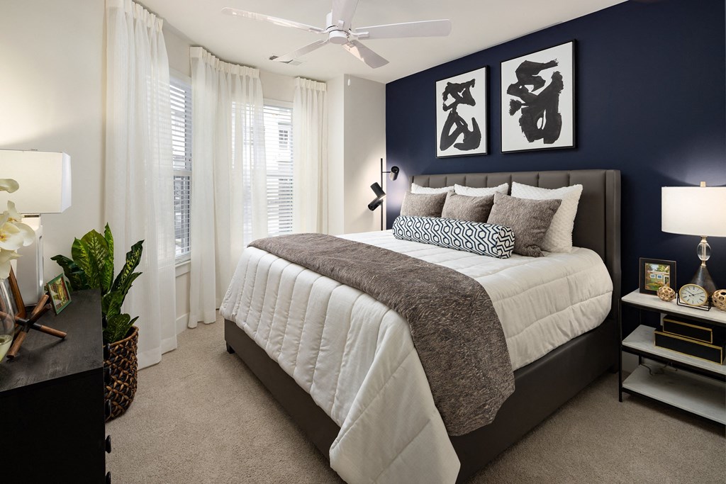 a bedroom with a large bed and a blue accent wall