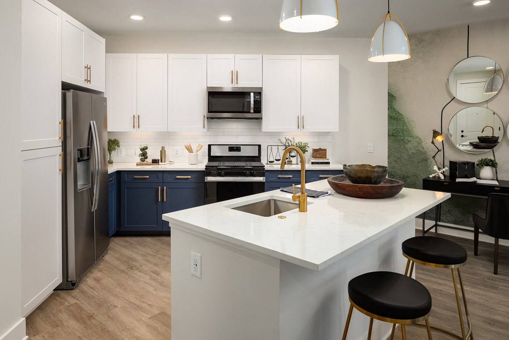 a kitchen with blue and white cabinets and a white counter top