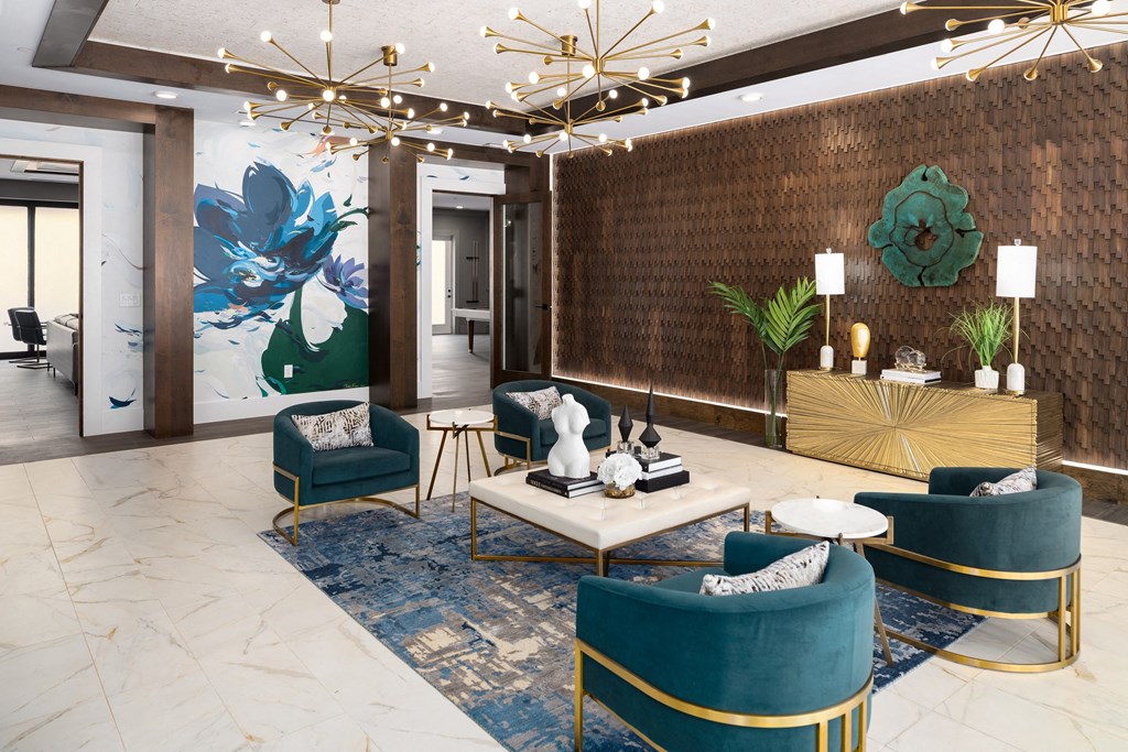 a lobby of a hotel with blue chairs and a white table