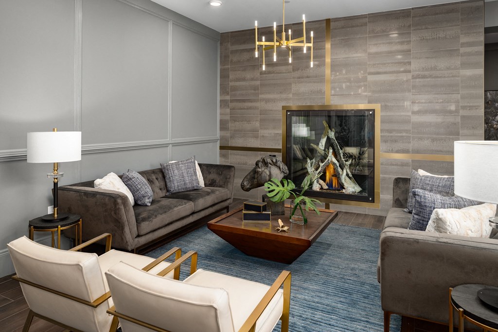 a living room with couches chairs and a coffee table and a fireplace