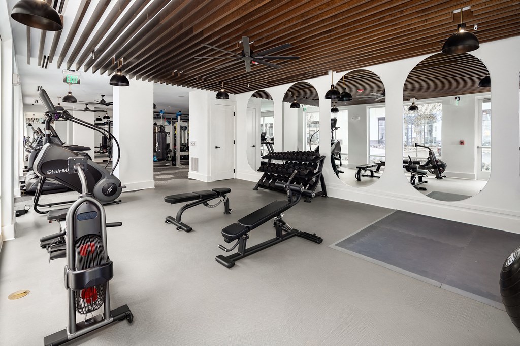 a gym with treadmills and other exercise equipment in a building